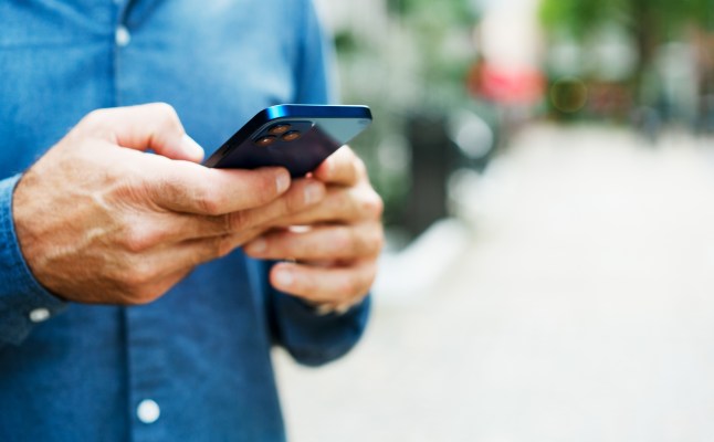 Close up of man using smart phone