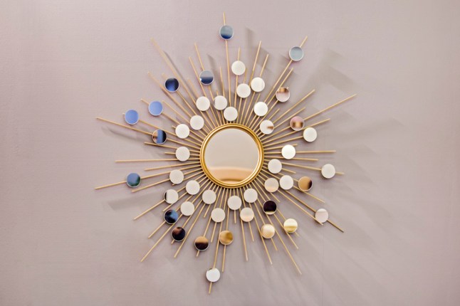 Decorative wall round mirror in the shape of the sun, a golden cooper mirror, modern shape in the Scandinavian style