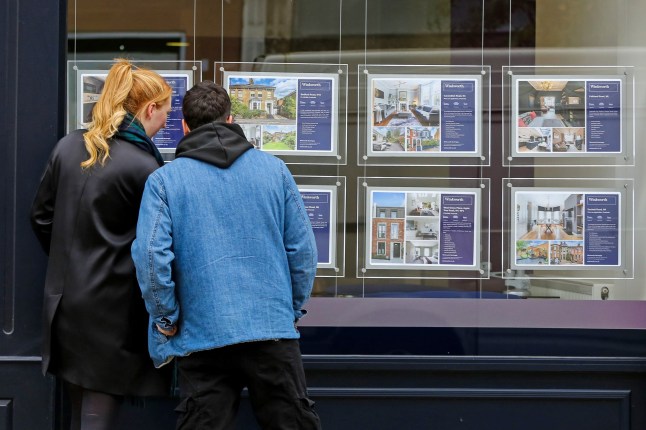 Mandatory Credit: Photo by Dinendra Haria/LNP/REX/Shutterstock (12589143e) A couple look at the properties for sale displayed in an estate agent's office window. The Bank of England has left interest rates at their record low level of 0.1%, despite forecasting a jump in inflation to 5% by next spring. This is after major lenders began pulling their cheapest mortgage deals in anticipation of a rise last month. House prices have risen almost 10 per cent in the year to October 2021. According to Nationwide, the average cost of a home in the UK is above ??250,000 - the first time it has risen to over the quarter of a million pound mark. Bank of England keeps interest rates on hold at 0.1%, London, UK - 04 Nov 2021