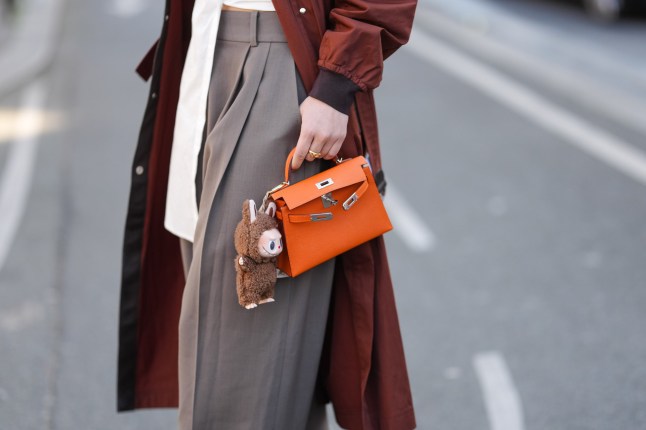 A Labubu doll on an orange Hermes bag at Paris Fashion week.